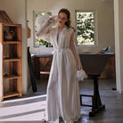 "Luxury silk-blend robe" "Elegant feather-cuffed loungewear" "Embroidered belt robe" "High-end silk robe for home" "Sophisticated lounging attire"